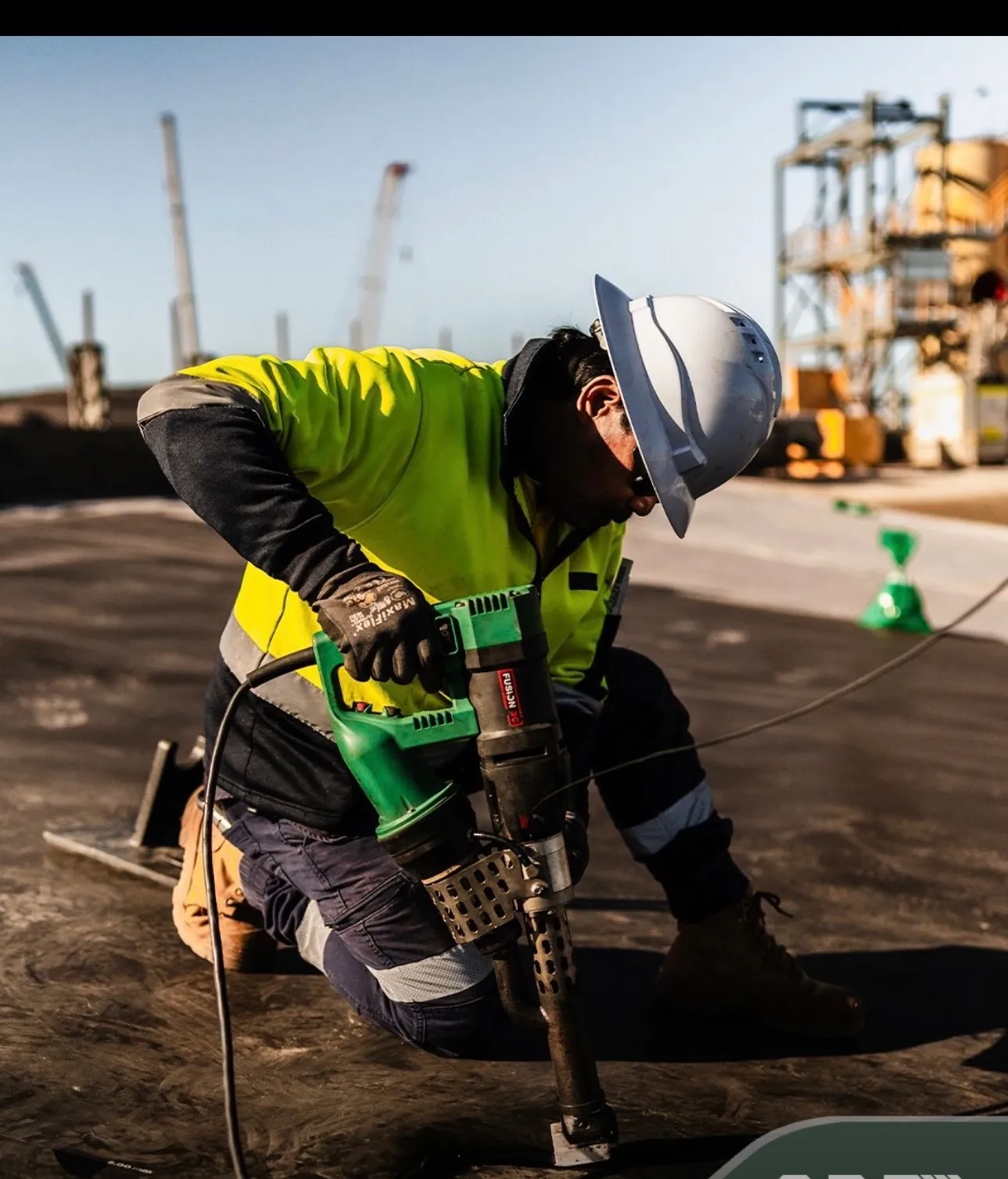 Geomembrane technician extrusion welding an HDPE liner seam on site